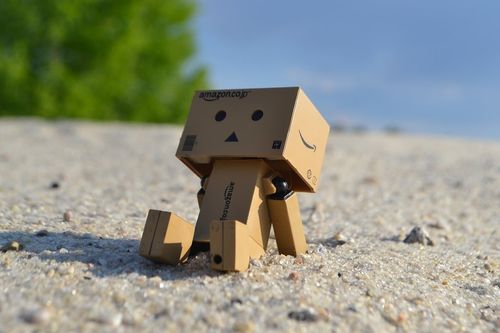 Cardboard robot on beach